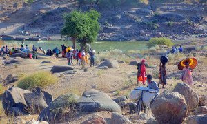 Ethiopian refugees, fleeing clashes in the country's northern Tigray region, cross the border into Hamdayet, Sudan, over the Tekeze river.