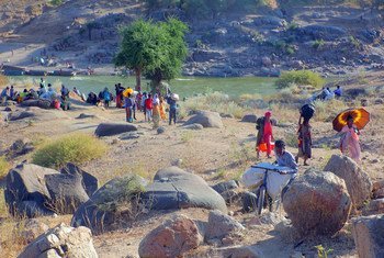 Ethiopian refugees, fleeing clashes in the country's northern Tigray region, cross the border into Hamdayet, Sudan, over the Tekeze river.