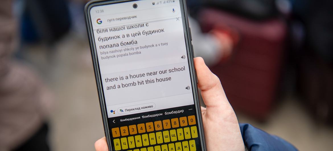 A young Ukrainian refugee using Google translate, Poland.