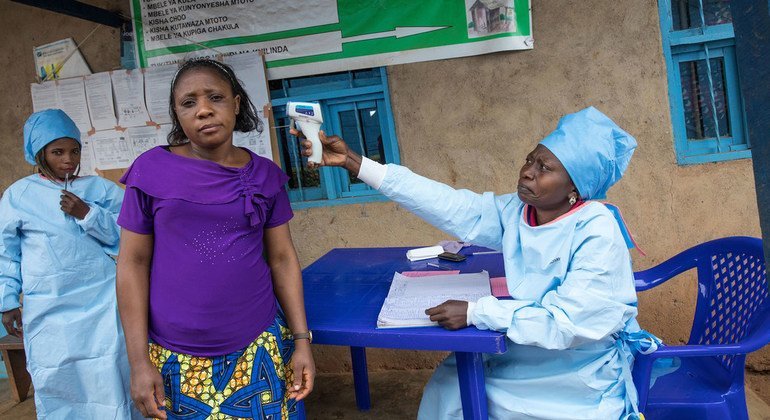 A patient at a health centre in Butembo in the east of the Democratic Republic of the Congo has her temperature measured as part of efforts to prevent the spread of Ebola. (August 2019)