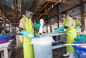 Le personnel d'un centre de traitement d'Ebola à Butembo, dans l'est de la RDC, désinfectent leurs bottes et nettoient leurs vêtements. 
