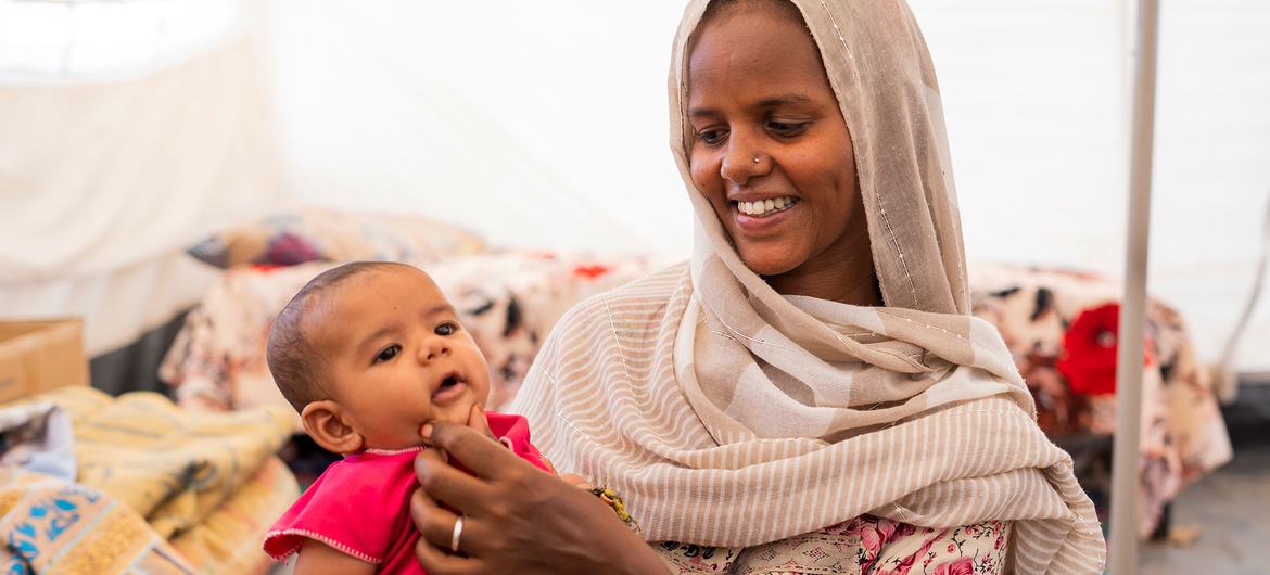 An Ethiopian mother and her child live with six other family members in a small hut at the Um Rakuba Refugee camp in eastern Sudan.