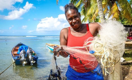 A woman fisher prepares her nets on the Caribbean Island, Dominica.