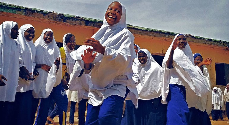 Schoolgirls in Nigeria enjoy a break from class.