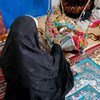 Uma afegã, mãe de seis crianças, agora vive com a família no Irã.