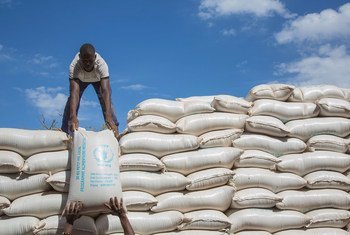 Workers offload sacks of flour at the WFP warehouse in Kaya, Burkina Faso.