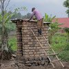 A professional builder constructs a toilet in his community in Burera district, Rwanda. The builder was trained by UNICEF and the NGO Society for Family Health to build hygienic and safe toilets.