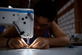 Former farmer Monica Astrid Oquendo works in a tailor shop as part of a process to return to a life without conflict in Colombia.