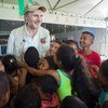 O Embaixador da Boa Vontade do Unicef, Liam Neeson, interage com um grupo de crianças em um espaço do Unicef adaptado para crianças no Centro de Registro em Pacaraima.