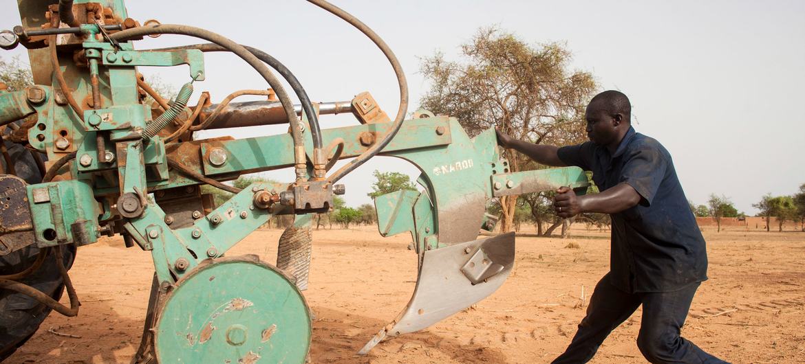 Workers preparing tractors to start ploughing in Burkina Faso.