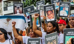 Mothers stand up in memory of their sons killed in the context of police operations.