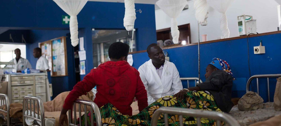 A nurse chats with a woman receiving chemotherapy in a hospital in Burera District, Rwanda.
