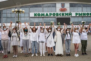 Women protesters hold hands in solidarity  over the disputed presidential election in Belarus.