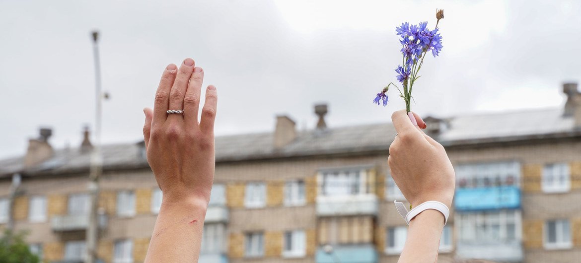 A flower is held in peaceful protest against the disputed presidential election in Belarus.