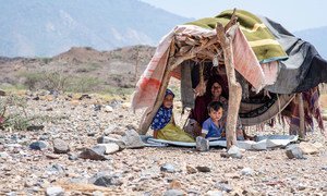 A displaced woman and her children in a makeshift shelter on the west coast of Yemen.