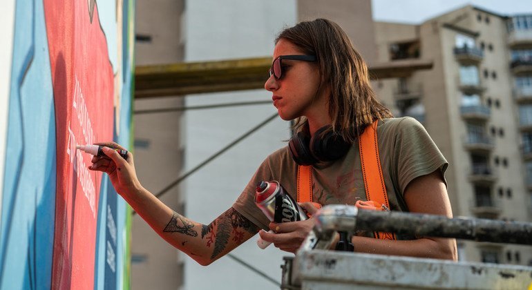 Musya Qeburia works on a piece of wall art in Tbilisi, Georgia. Her ability to leave such a visual mark on her city is a reflection of the openness Georgia has achieved with support from the UN. 