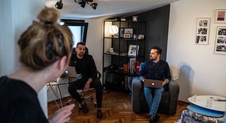 Darko speaks with some of his colleagues at the offices of his communications firm in Belgrade, Serbia.