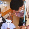Dans un centre de santé de Ouagadougou, la capitale du Burkina Faso, Dre Marie Marcos, Spécialiste santé à l'UNICEF Burkina Faso, aide les infirmières à vacciner les enfants.