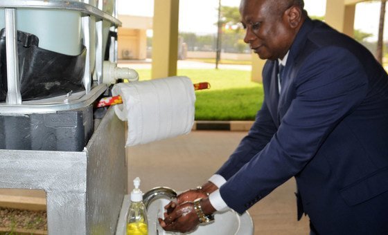 The UN Resident Coordinator in Nigeria, Edward Kallon, washes his hands, demonstrating one way to reduce the transmission of the coronavirus.