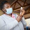 A health worker prepares to carry out a COVID-19 vaccination in Uganda.