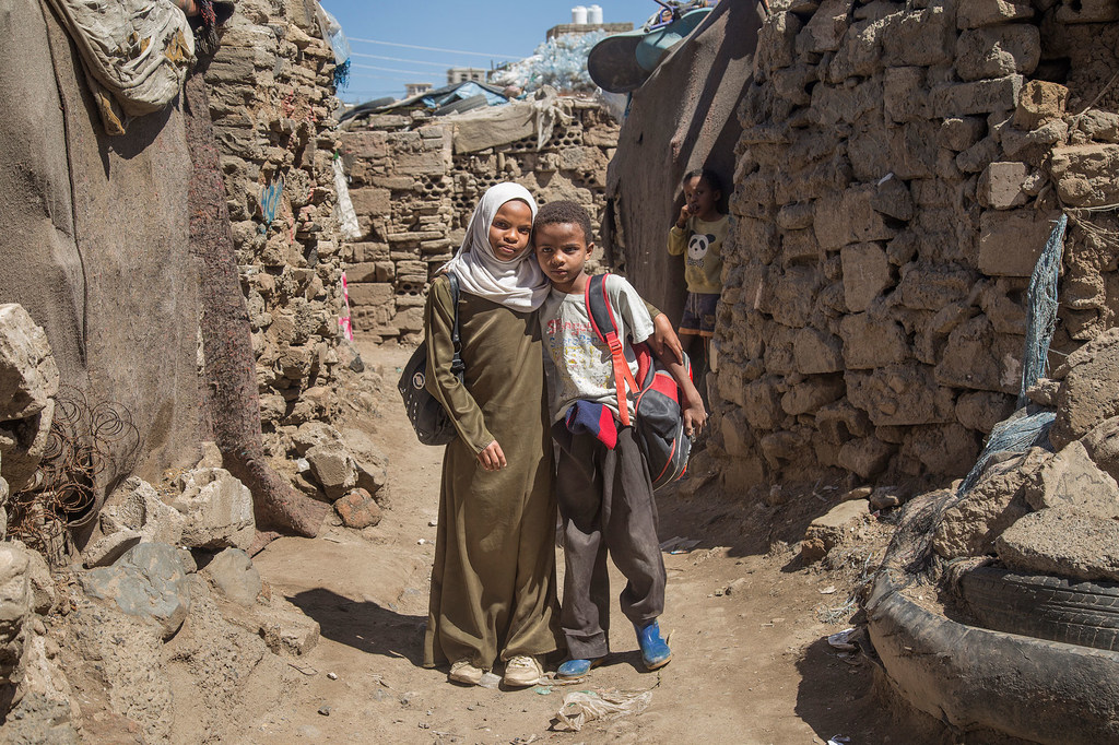 A twelve-year-old Yemeni girl and her brother tutor math.