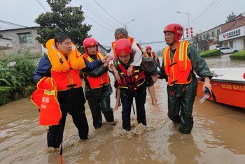 Emergency workers rescue an elderly person in Xuchang, in China's Henan Province.