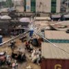 مشهد من مدينة لاغوس النيجيرية من خلال نافذة زجاجية مشروخة بفعل الرصاص.