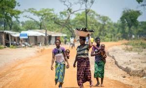Refugee women from the Democratic Republic of the Congo walk towards the market in Mantapala Settlement, Zambia. 