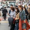 People with protective masks walk in the street of Tokyo, Japan.
