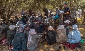 A joint team of United Nations police, Central African defense and security forces, and MINUSCA, interact with the population of Kidjidji, to assess the security situation, in Central African Republic