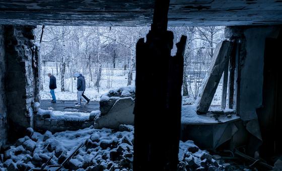 People outside a residential building destroyed by shelling in Marinka, Ukraine.  (file)