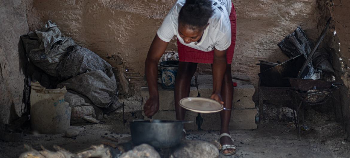A woman prepares a meal in Haiti.