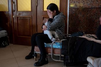 Ukrainians at Lviv train station prepare to leave their country.