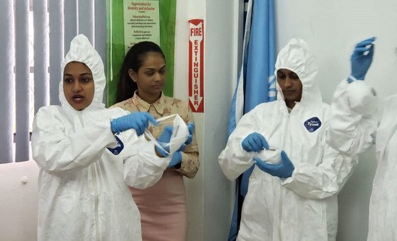 Health workers in Guyana learn how to safely dress in  personal protective equipment (PPE).