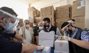 The first delivery of COVID-19 vaccines supplied through the COVAX Facility is unpacked in Syria.  