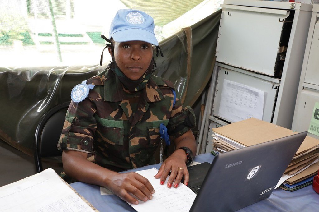 Mlinda amani mwanamke Mtanzania aliyevaa sare ya kujificha na kofia ya bluu UN anafanya kazi kwenye dawati katika ofisi ya utawala.