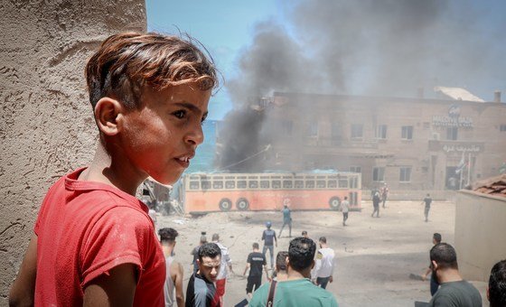 A Palestinian child in front of the Gaza port, which was damaged during the recent escalation.