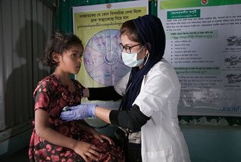 A medical assistant examines a seven-year-old girl in Cox’s Bazar, Bangladesh.