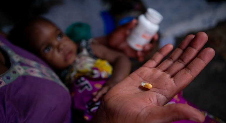 أم في مبارارا، غرب أوغندا، تتأكد من أن يتلقى طفلاها دواء فيروس نقص المناعة البشرية للأطفال في نفس الوقت كل يوم.