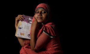 A fourteen year-old Rohingya refugee holds her favorite book of poetry at a refugee camp in Cox's Bazaar, Bangladesh.