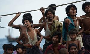 Stranded Rohingya boat people, desperate for food and water, sit on the deck of an abandoned smugglers' boat drifting in Thai waters off the southern island of Koh Lipe in the Andaman sea. (file)