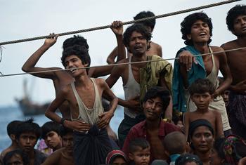 Stranded Rohingya boat people, desperate for food and water, sit on the deck of an abandoned smugglers' boat drifting in Thai waters off the southern island of Koh Lipe in the Andaman sea. (file)