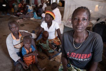 In the Democratic Republic of the Congo, Jeanette Buse Lasi, a widowed mother of four, sits with her children inside a communal shelter in an IDP camp in Bunia.