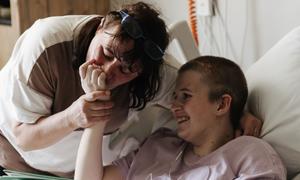 Lyudmila kisses her 13-year-old daughter Sofia's hand who is recovering after surviving a shell attack, at the specialized children's hospital ‘Okhmatdyt’ in Kyiv.