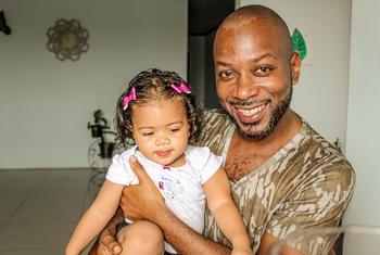 Kendall Cayas, afrodescendiente costarricense, sostiene en su regazo a una niña.