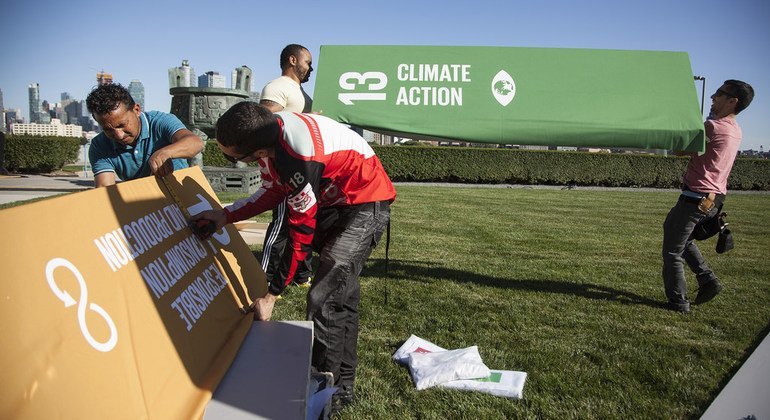 From left, Jose Medrano, Edimer Valle and Arnel Ojeda build the SDG Action Zone on the grounds of UN Headquarters in preparation for the High-Level Week.