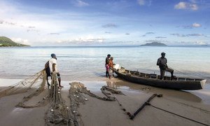 Fishermen at Beau Vallon beach in the Seychelles prepare their nets for fishing.