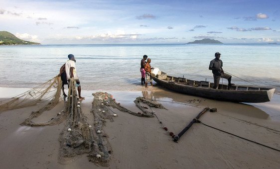 Fishermen at Beau Vallon beach in the Seychelles prepare their nets for fishing.