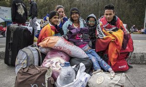 Venezuelanos aguardam para atravessar a fronteira entre Colômbia e Equador