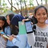 Indonesian adolescent girls use their smartphones.